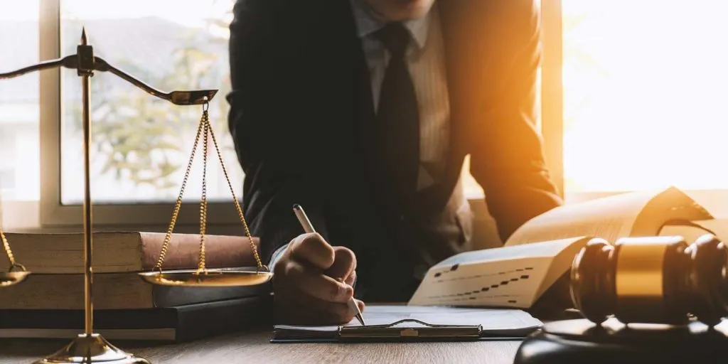 Attorney writing down law firm marketing ideas