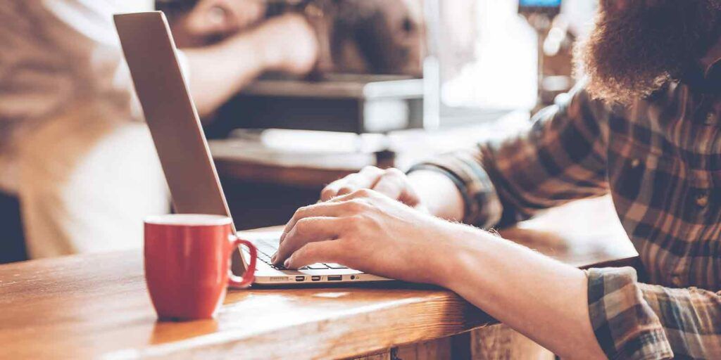 man working on updating his old blog for content marketing
