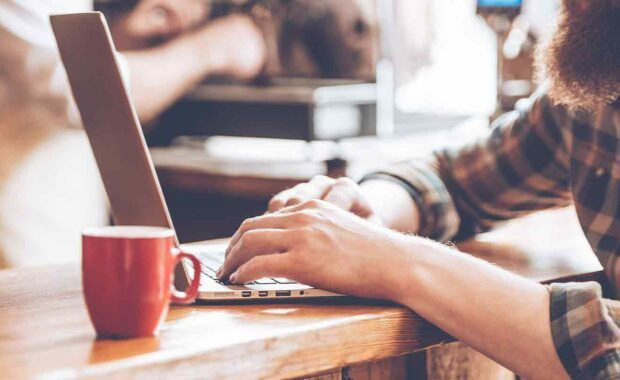 man working on updating his old blog for content marketing