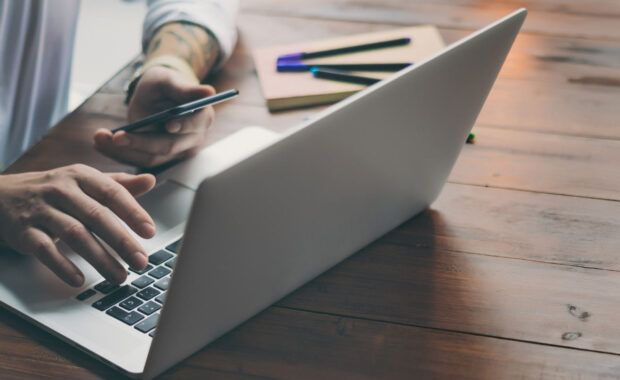 Person typing on their laptop
