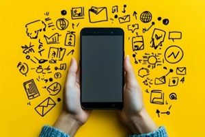 hands holding smartphone with social media icons drawn around it