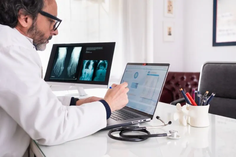Doctor Reviewing His Healthcare Marketing Campaign Data