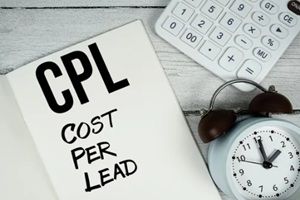 cost per lead text on paper notebook page with alarm clock and calculator on wooden background