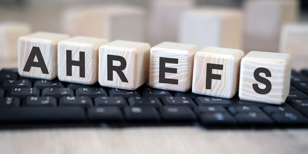 ahrefs - text cubes stand on a black keyboard on a wooden table