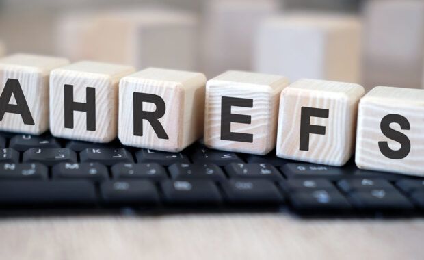 ahrefs - text cubes stand on a black keyboard on a wooden table