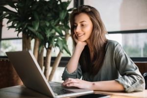 Successful freelancer typing on keyboard using laptop computer i